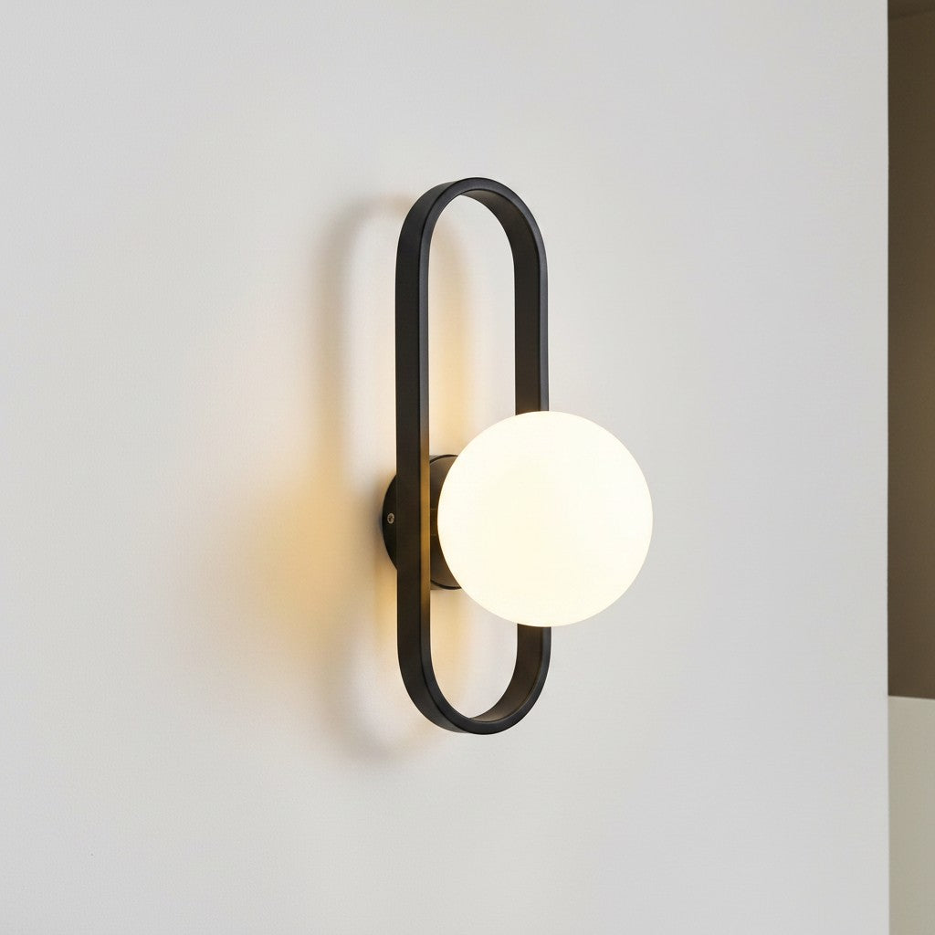 GoldenWatt luxury LED wall sconce with a black iron frame and a round frosted glass globe shade for modern interiors.
