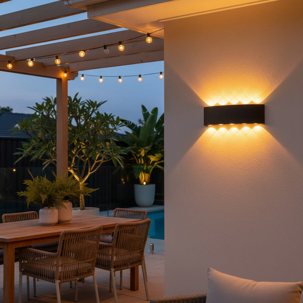 GoldenWatt black rectangular LED wall sconce casting warm up and down light on a modern outdoor patio wall