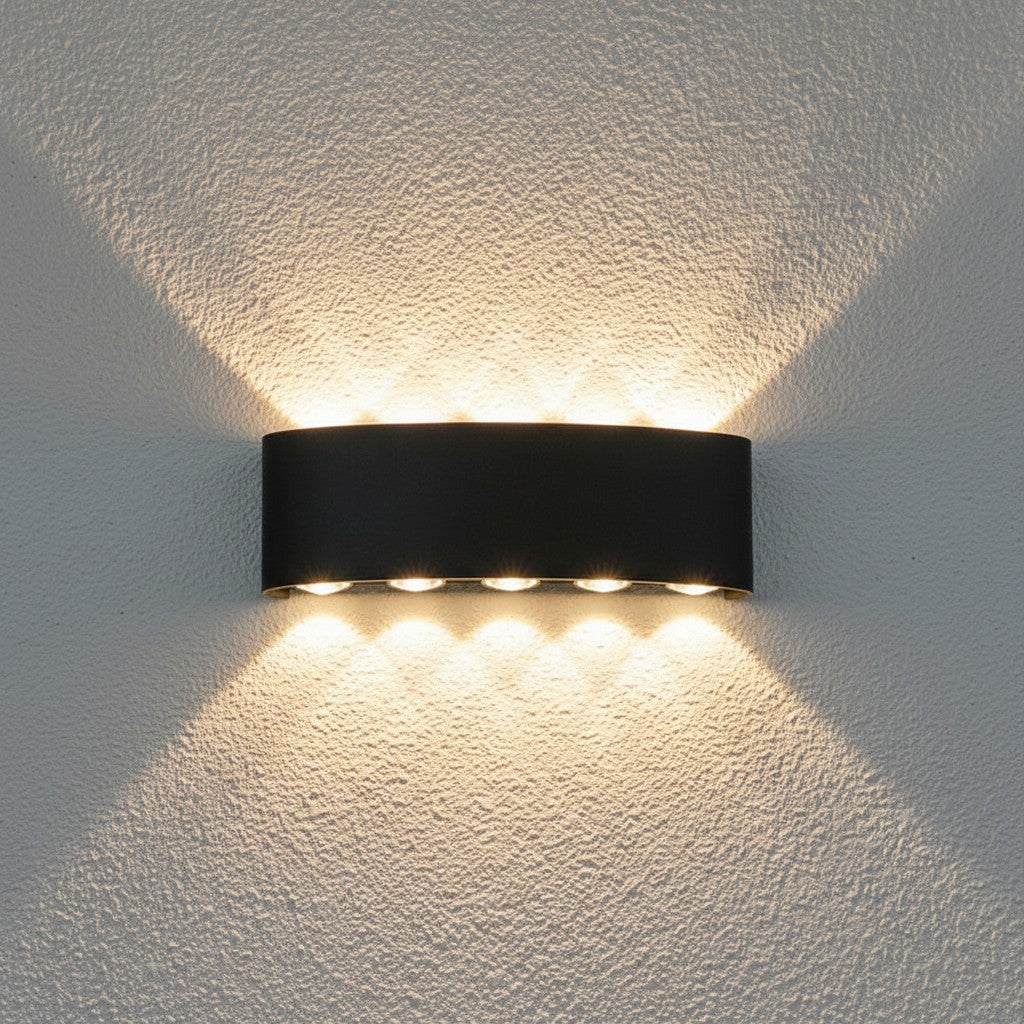 GoldenWatt black moisture-resistant LED wall sconce with up and down directional lighting on a textured wall