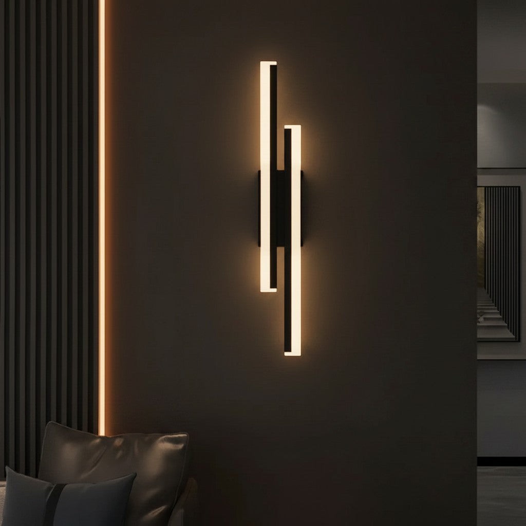 GoldenWatt dimmable LED wall sconce in black with vertical iron and acrylic strips emitting warm ambient light