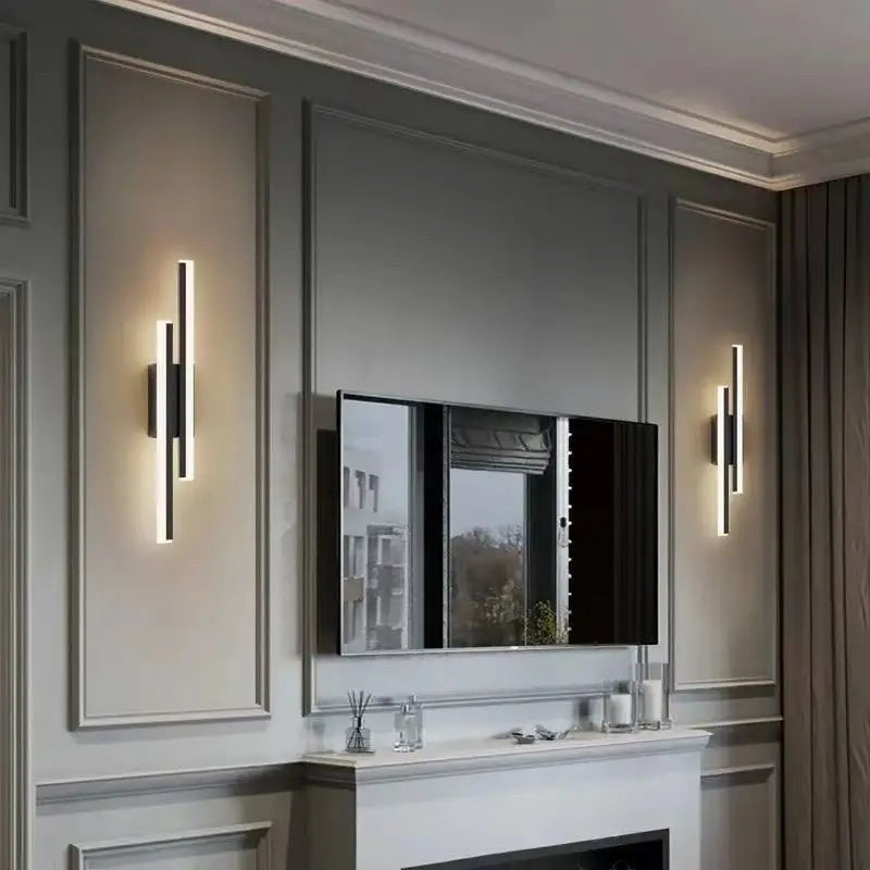 GoldenWatt dimmable LED wall sconces in black and gold mounted on a grey living room wall beside a television