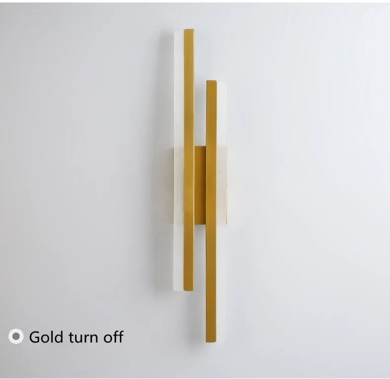 GoldenWatt dimmable LED wall sconce in gold finish with acrylic accents, shown in off state against a white wall.