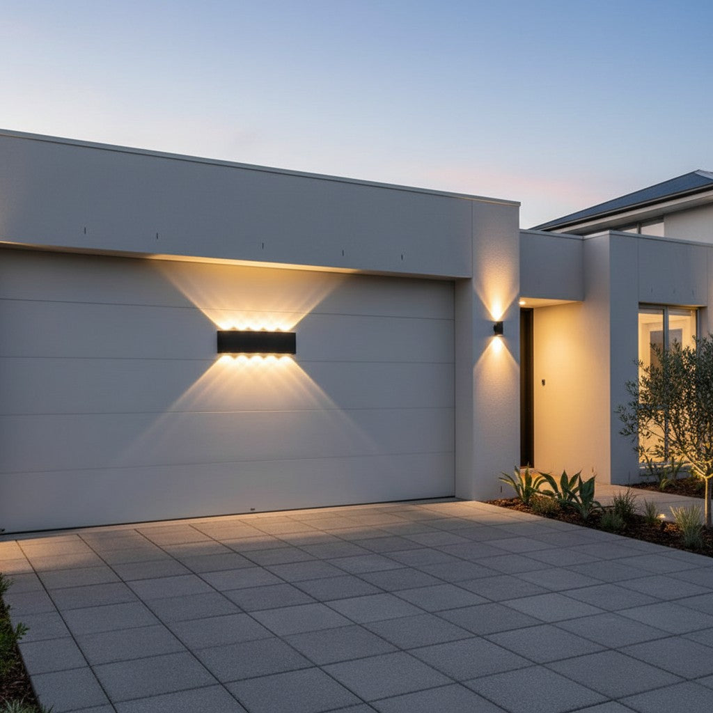 GoldenWatt modern black LED outdoor wall sconce providing up and down directional lighting on a contemporary home exterior