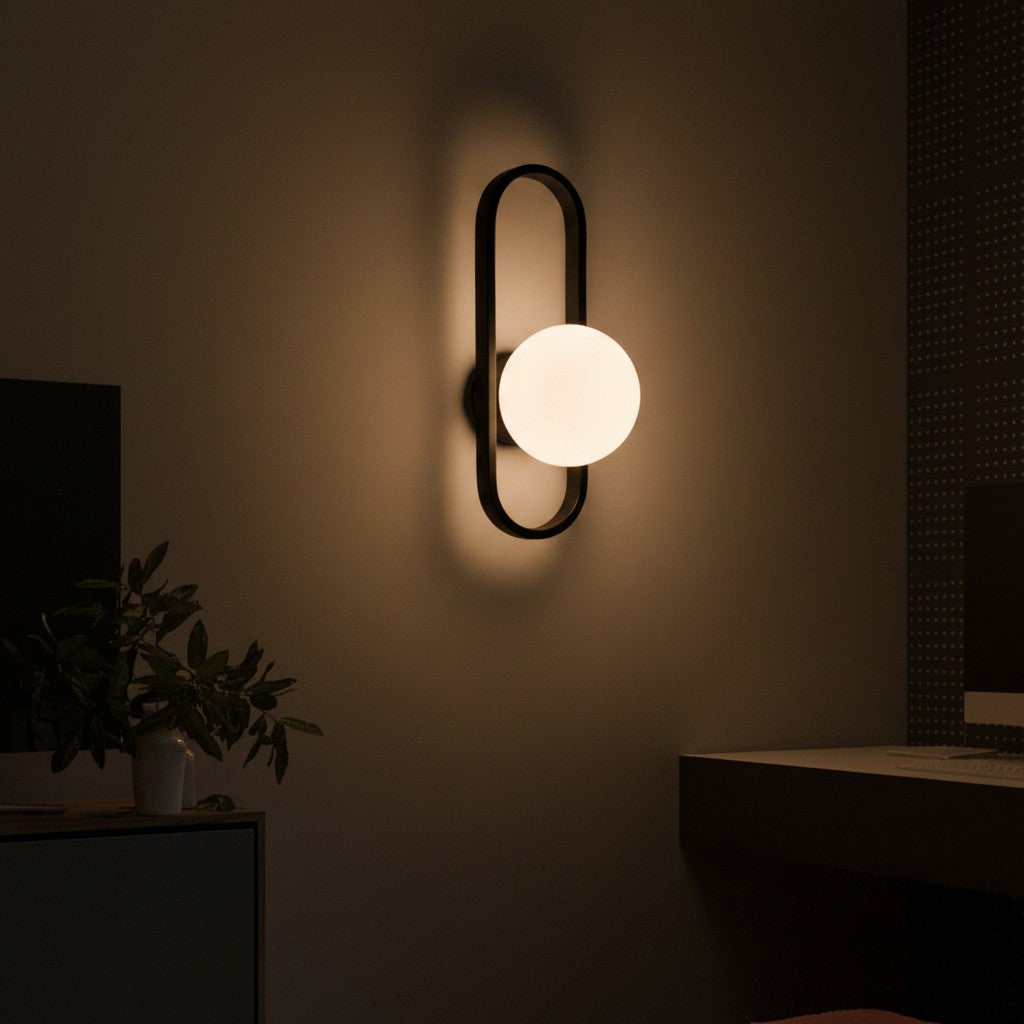 GoldenWatt luxury LED wall sconce with a frosted glass globe shade and black iron frame glowing in a modern room