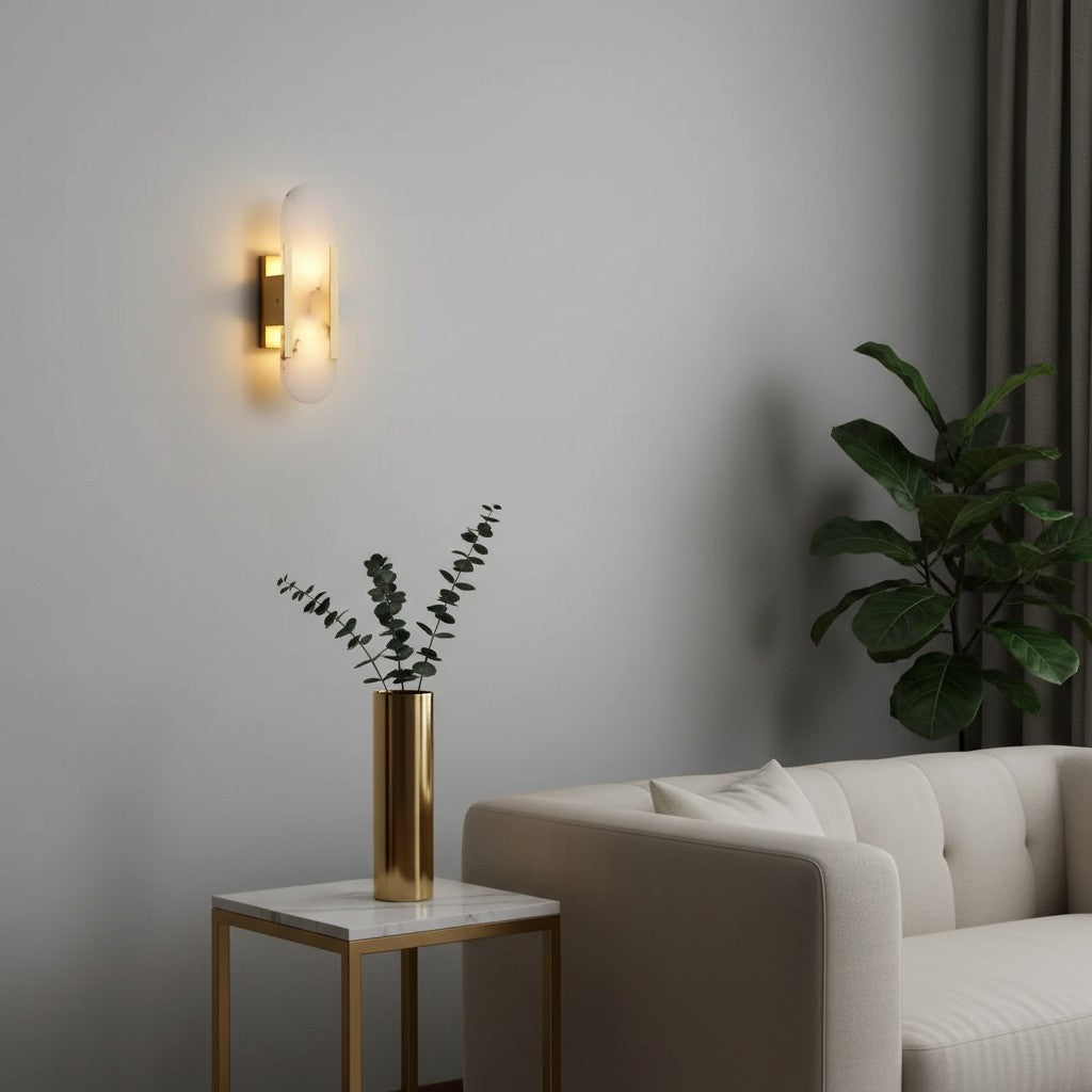 GoldenWatt marble and gold-plated LED wall sconce emitting warm light in a modern living room interior.