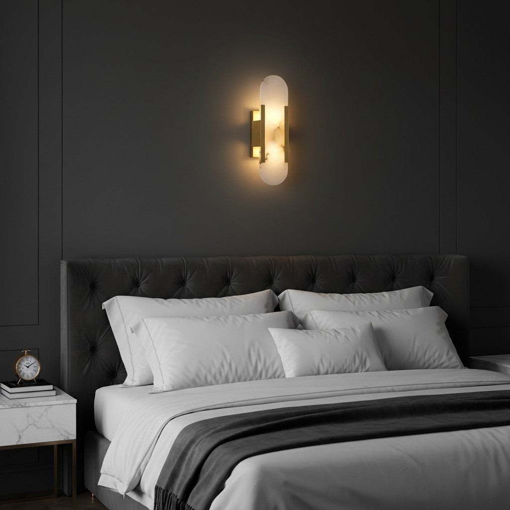 GoldenWatt marble LED wall sconce with gold-plated metal frame mounted above a modern bedroom bed