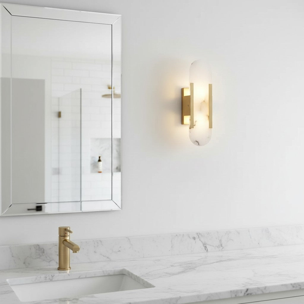 GoldenWatt marble LED wall sconce with gold-plated metal frame, mounted in a modern bathroom above a marble vanity.