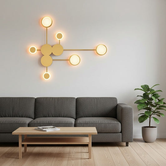 GoldenWatt modern minimalist wall lamp with multiple glowing circular LED heads in a gold finish above a sofa