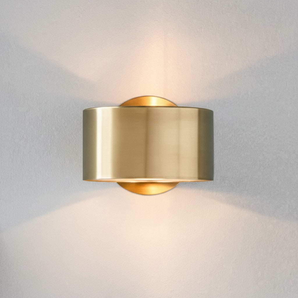 GoldenWatt Nordic modern gold iron wall sconce emitting warm white light on a neutral wall