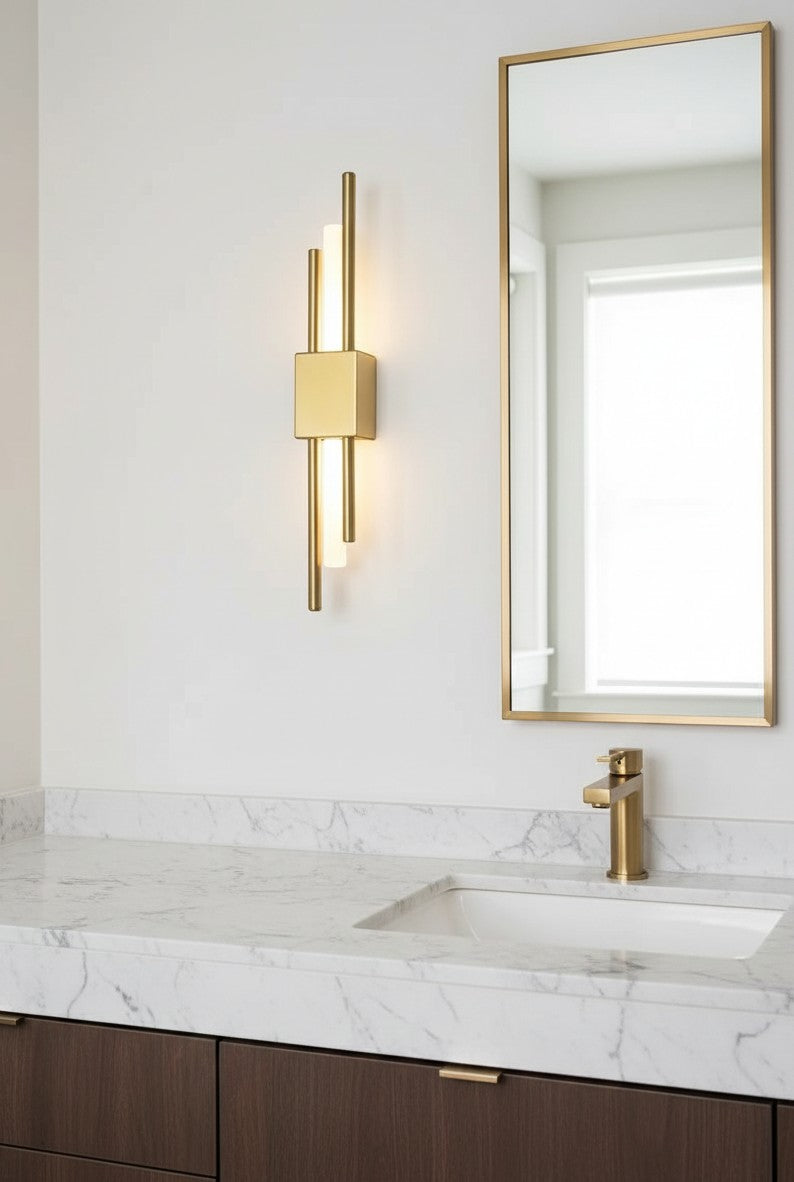 GoldenWatt Nordic LED wall sconce in gold finish with acrylic accents, mounted beside a bathroom mirror.