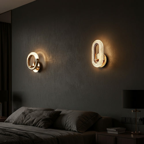 GoldenWatt Nordic gold LED wall lamps with acrylic detailing mounted on a dark bedroom wall with warm ambient lighting