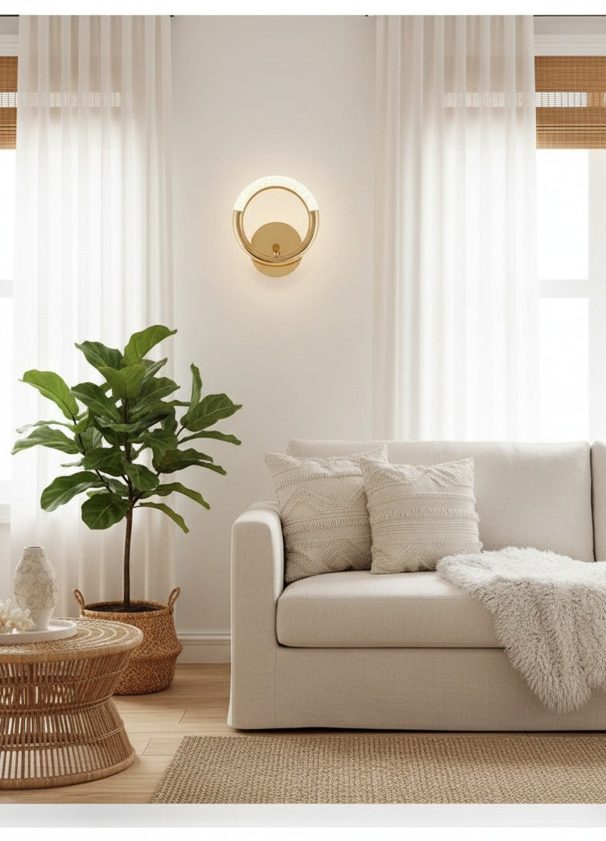 GoldenWatt Nordic gold LED wall lamp with circular design mounted above a beige sofa in a bright living room