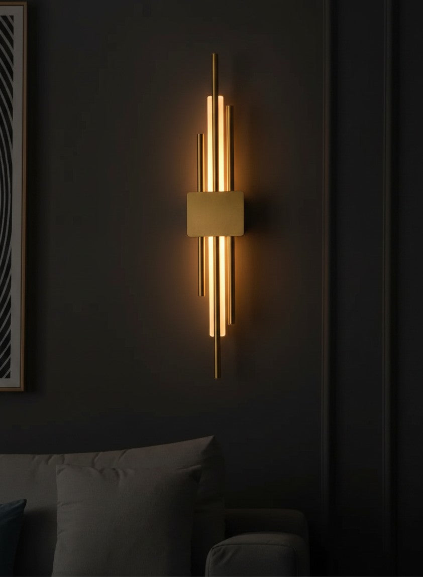 GoldenWatt Nordic contemporary LED wall sconce in gold with iron and acrylic, casting warm ambient light on a wall.