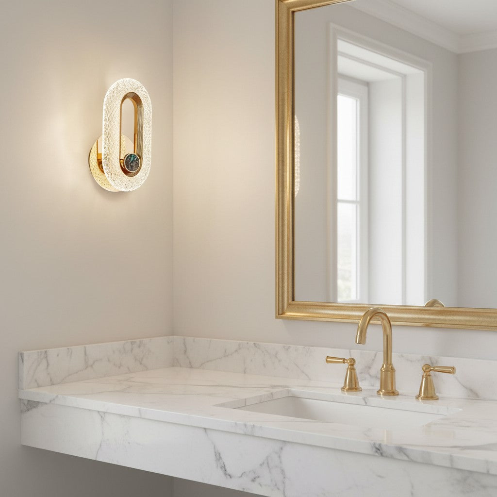 GoldenWatt Nordic gold LED wall sconce with textured acrylic detail, mounted in a modern marble bathroom vanity area.