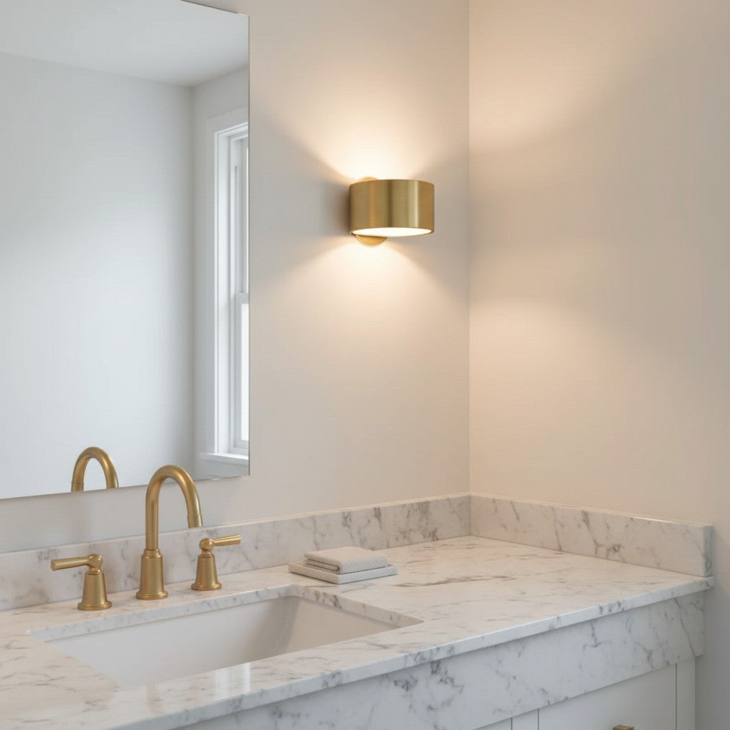 GoldenWatt Nordic gold iron wall sconce emitting warm white light above a marble bathroom vanity with gold faucet