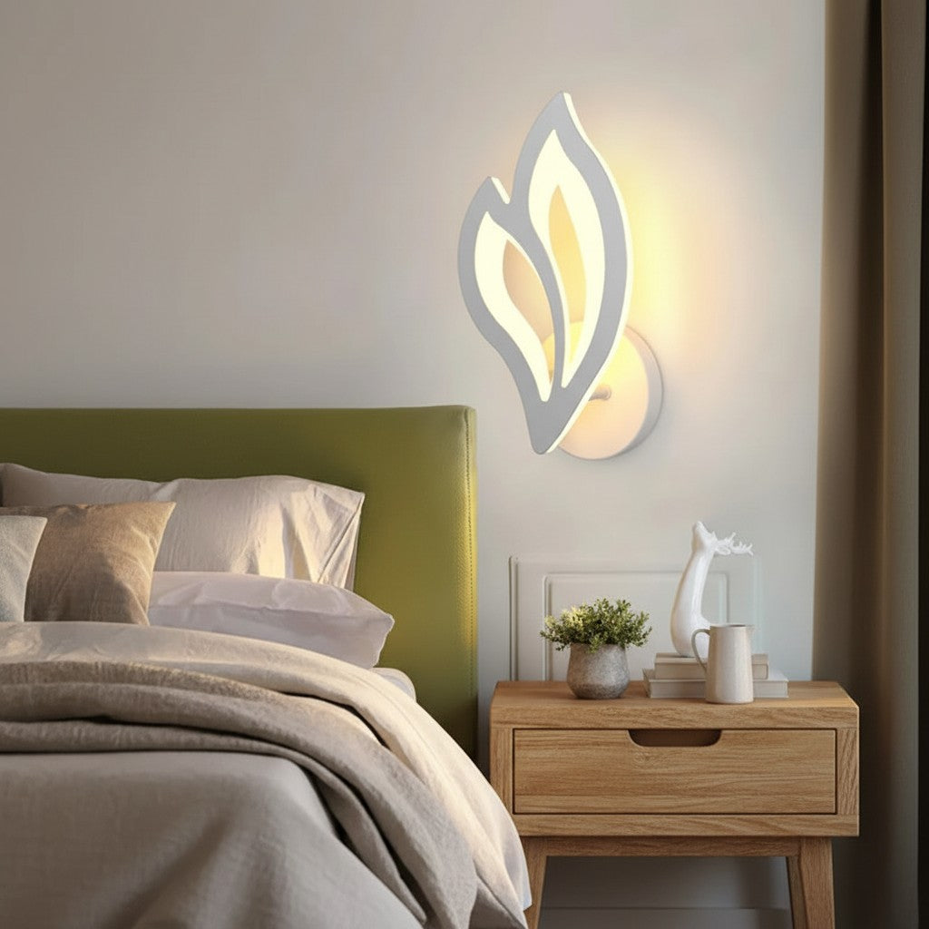 GoldenWatt modern white LED wall sconce with a leaf-shaped acrylic shade mounted above a wooden bedside table.